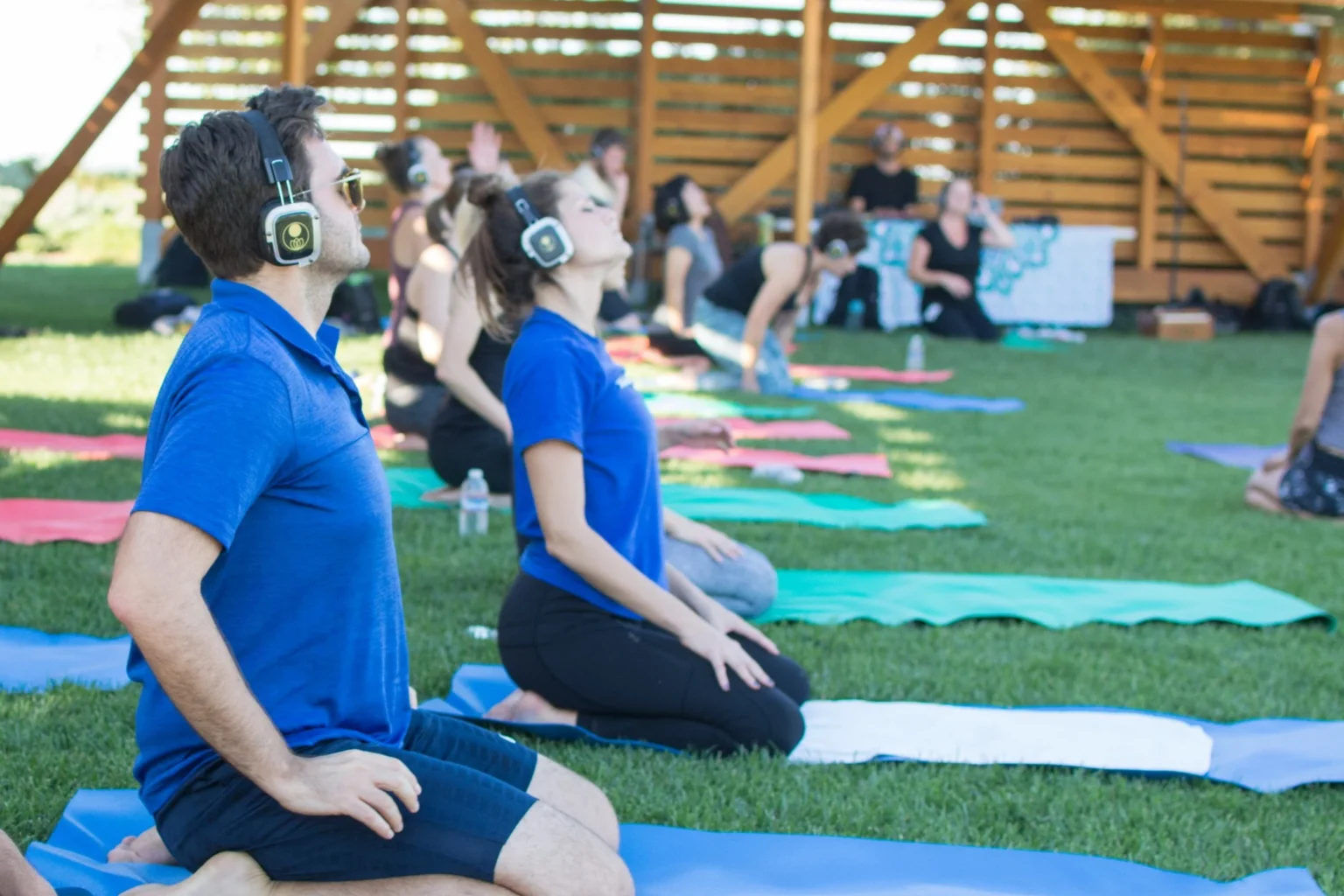 Employees participating in an outdoor corporate wellness yoga session